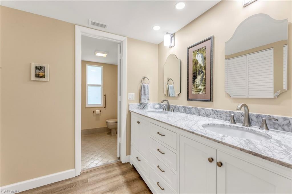 245 Quails Nest Road, Unit 3 Naples, FL 34112 - Photo 23 of 50 a bathroom with double vanity sink a mirror and a shower