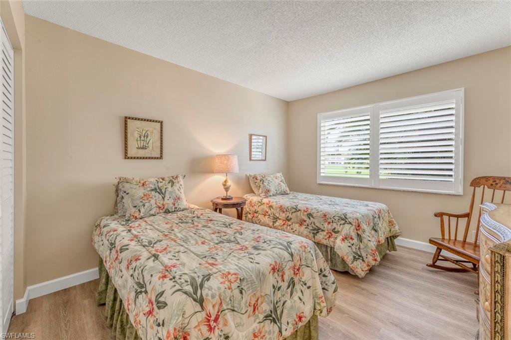 245 Quails Nest Road, Unit 3 Naples, FL 34112 - Photo 25 of 50 a bedroom with double bed and a window
