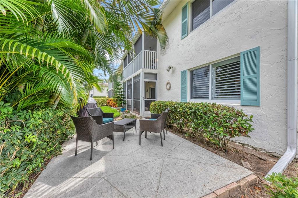 245 Quails Nest Road, Unit 3 Naples, FL 34112 - Photo 34 of 50 a view of a patio with furniture and a garden