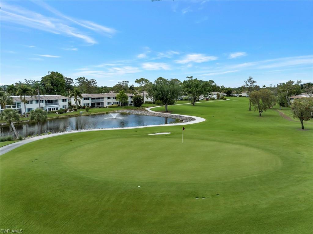 245 Quails Nest Road, Unit 3 Naples, FL 34112 - Photo 40 of 50 a view of a lake with houses in the back