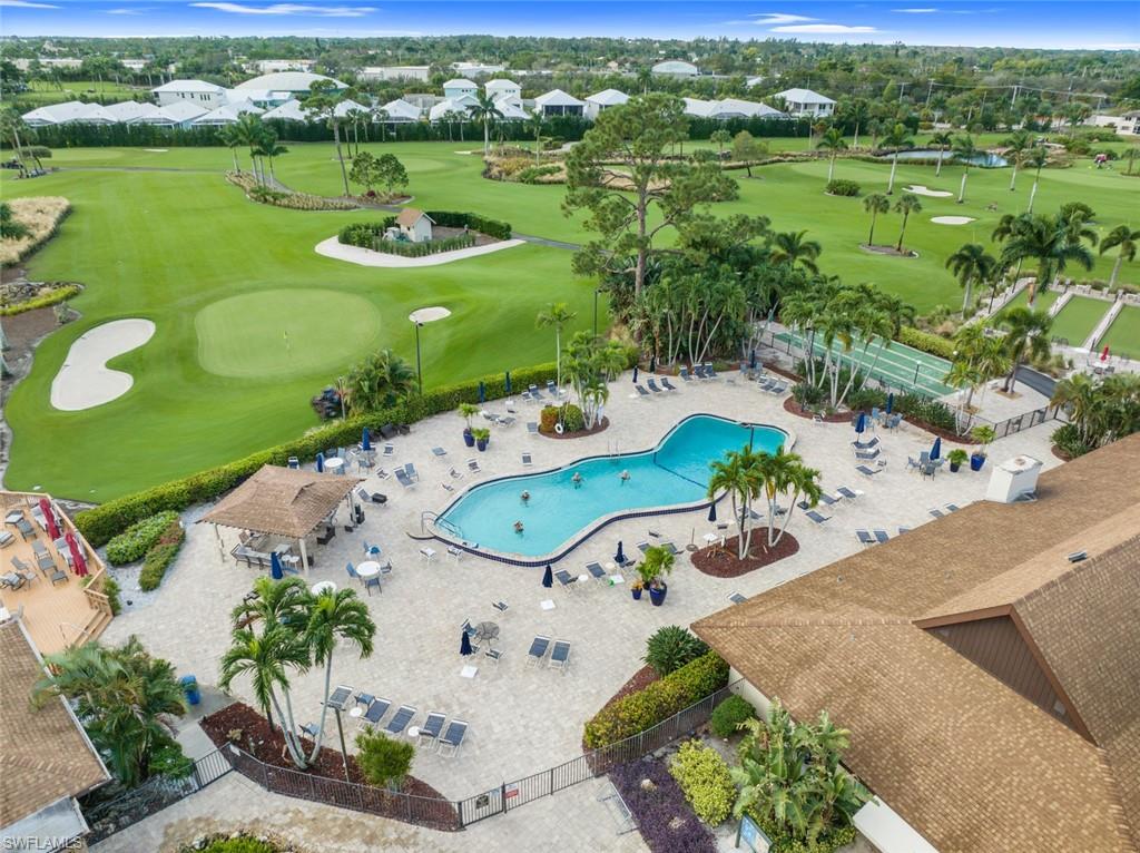 245 Quails Nest Road, Unit 3 Naples, FL 34112 - Photo 48 of 50 an aerial view of a pool a yard lake and outdoor seating