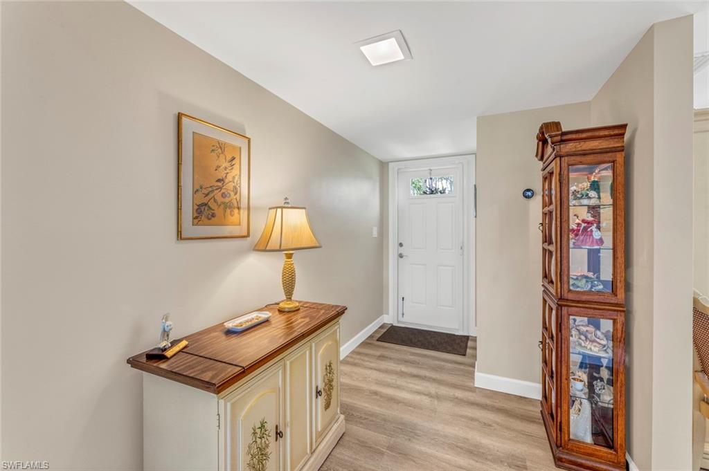 245 Quails Nest Road, Unit 3 Naples, FL 34112 - Photo 6 of 50 a bedroom with a bed and a table in it