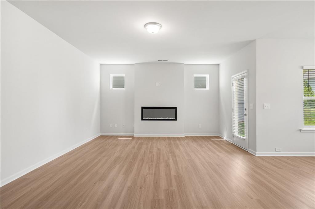 169 Andros Loop Dalton, GA 30721 - Photo 6 of 38 an empty room with wooden floor and windows