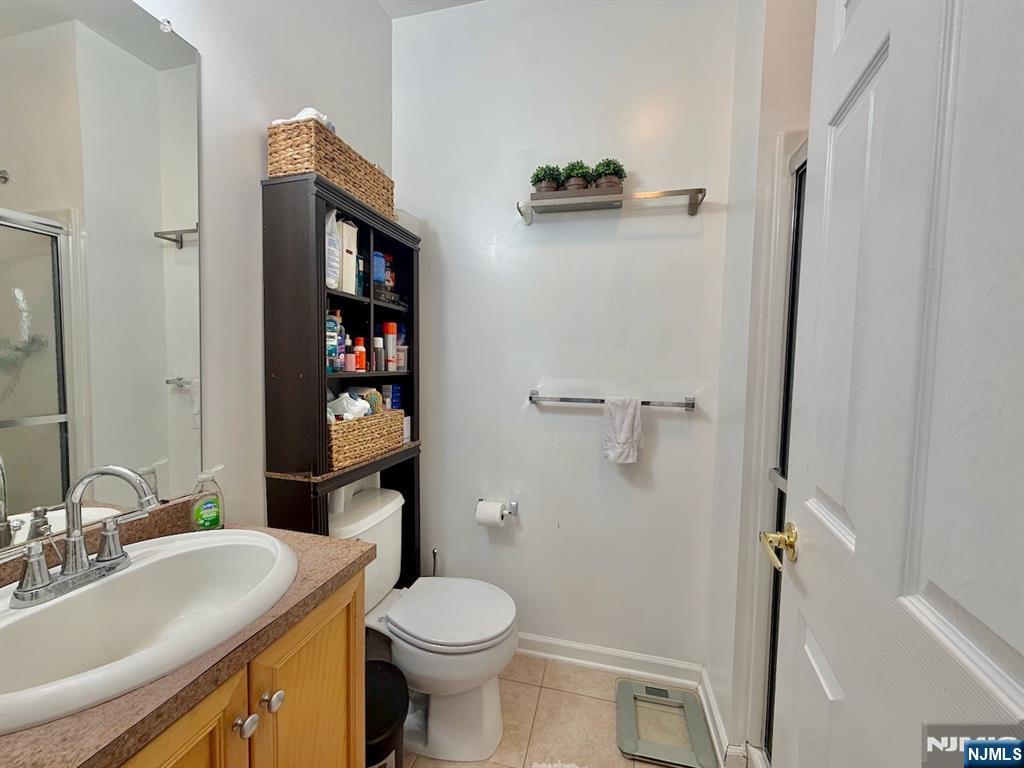 200 Dey Street, Unit 231 Harrison, NJ 07029 - Photo 12 of 19 a bathroom with a sink a toilet and shower