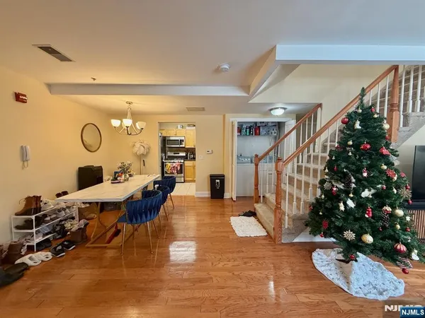 a living room with furniture potted plant and a chandelier