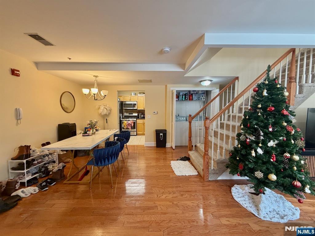 200 Dey Street, Unit 231 Harrison, NJ 07029 - Photo 3 of 19 a living room with furniture potted plant and a chandelier
