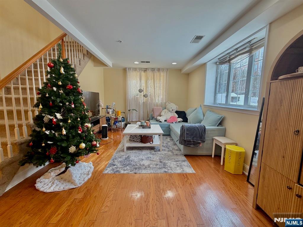 200 Dey Street, Unit 231 Harrison, NJ 07029 - Photo 4 of 19 a living room with furniture windows and a wooden floor