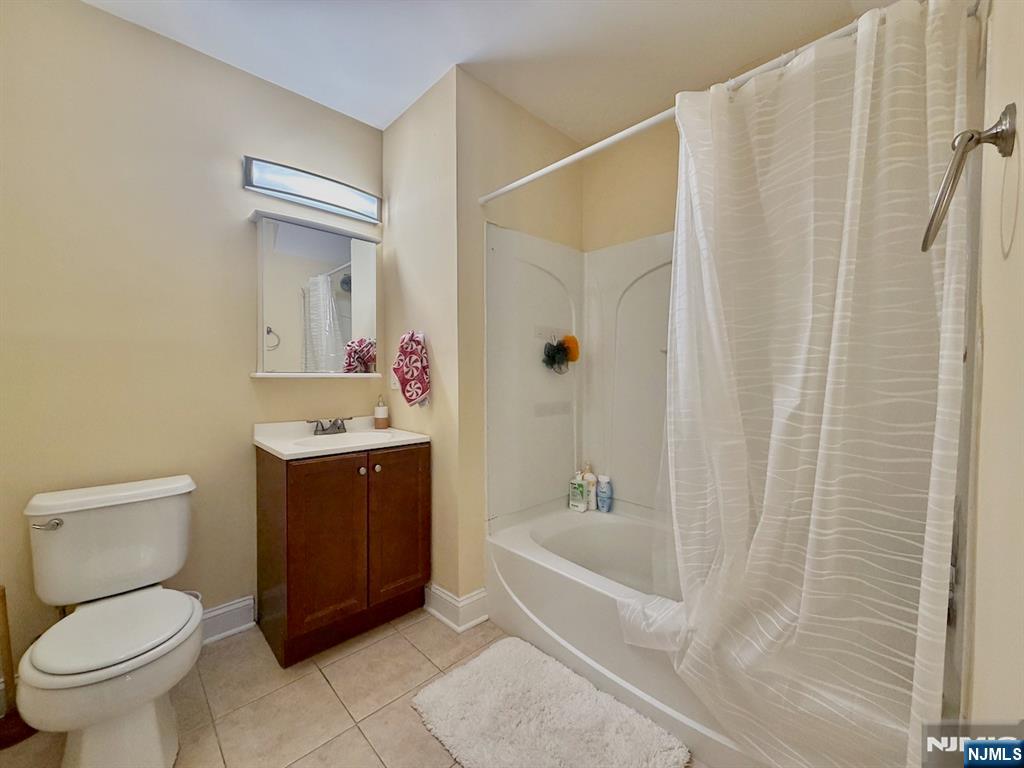 200 Dey Street, Unit 231 Harrison, NJ 07029 - Photo 9 of 19 a bathroom with a sink toilet and shower