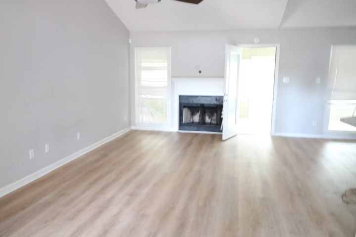 7935 Crescent Drive Columbus, GA 31909 - Photo 2 of 16 a view of an empty room with wooden floor fireplace and a window