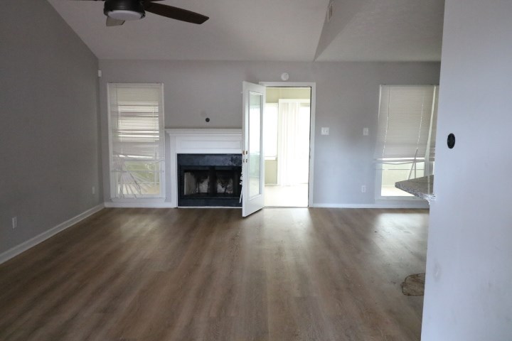 7935 Crescent Drive Columbus, GA 31909 - Photo 3 of 16 an empty room with wooden floor fireplace and windows