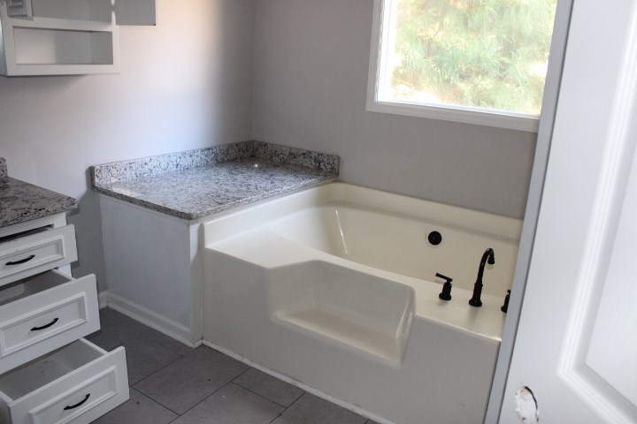 7935 Crescent Drive Columbus, GA 31909 - Photo 10 of 16 a white bath tub sitting next to a white sink