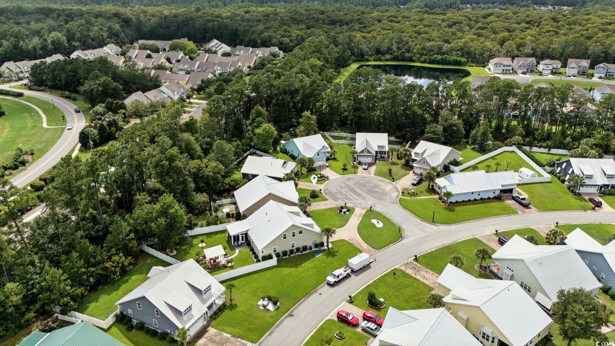 507 Percival Court Murrells Inlet, SC 29576 - Photo 35 of 38 Aerial perspective of suburban area with a nearby body of water and a forest