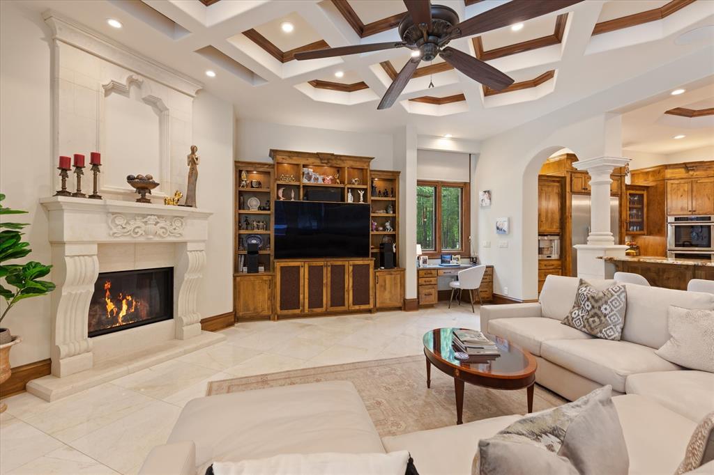 3705 Champions Ridge Lane Longview, TX 75605 - Photo 8 of 40 a living room with furniture a flat screen tv and a fireplace