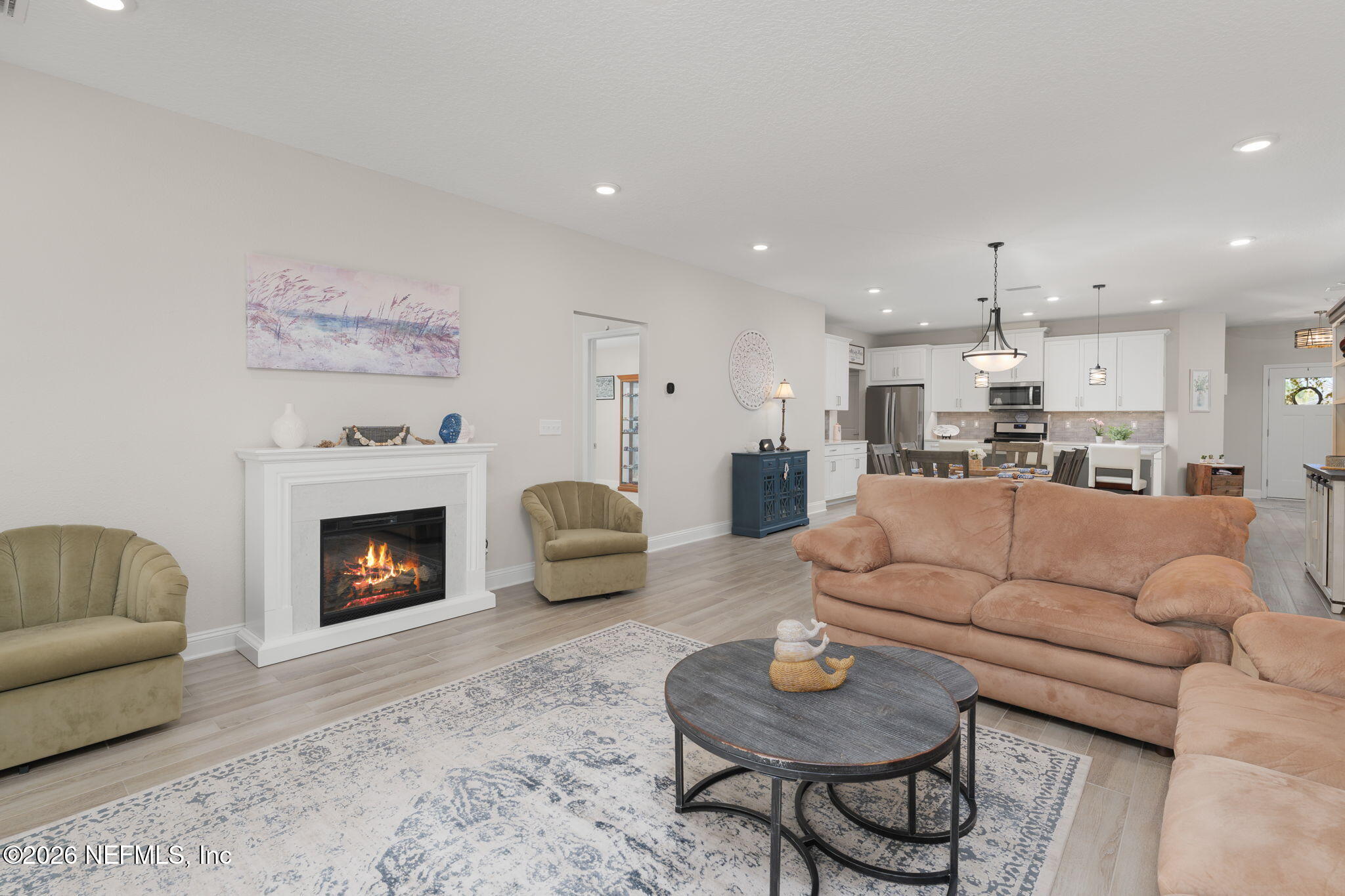 103 Riva Ridge Place St. Johns, FL 32259 - Photo 12 of 77 a living room with furniture kitchen view and a fireplace