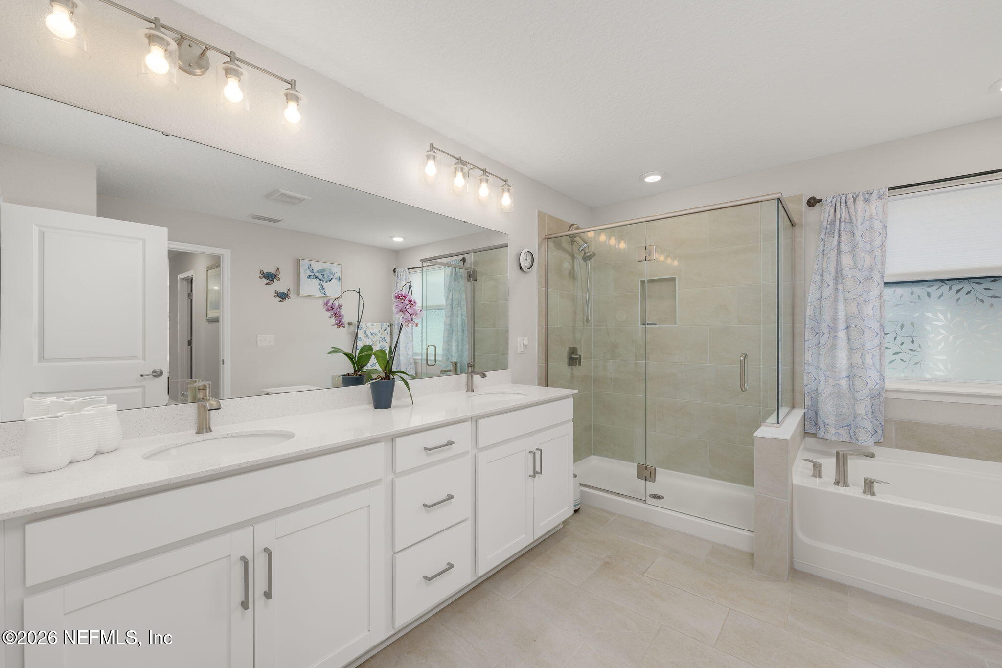 103 Riva Ridge Place St. Johns, FL 32259 - Photo 16 of 77 a spacious bathroom with a double vanity sink a large mirror and a bathtub