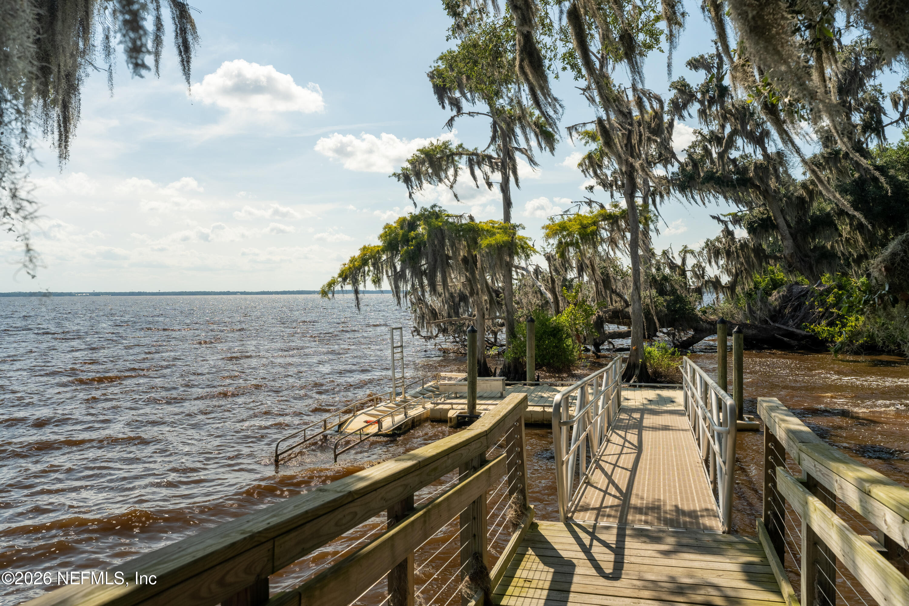 103 Riva Ridge Place St. Johns, FL 32259 - Photo 73 of 77 a view of a lake with a table and chairs