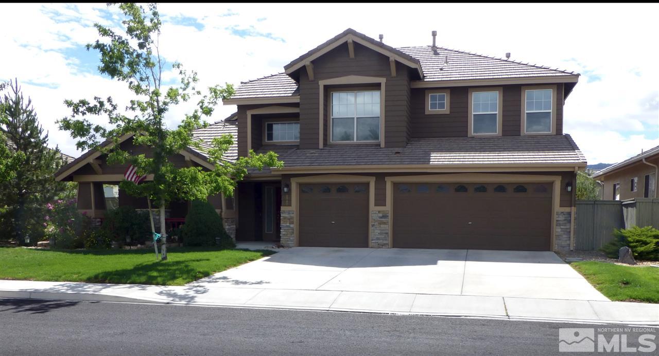 9980 Bandana Way Reno, NV 89521 - Photo 1 of 25 a front view of a house with a yard and garage