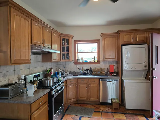 a kitchen with a sink stove top oven and cabinets