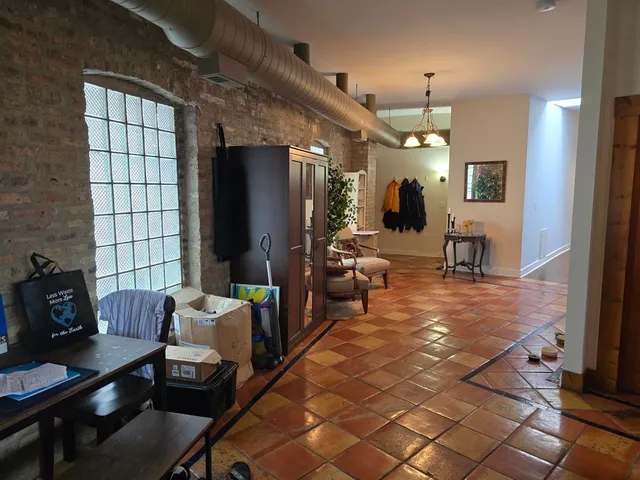 a living room with furniture a dining table and a fireplace