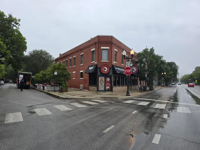 a man walking down a street next to a building