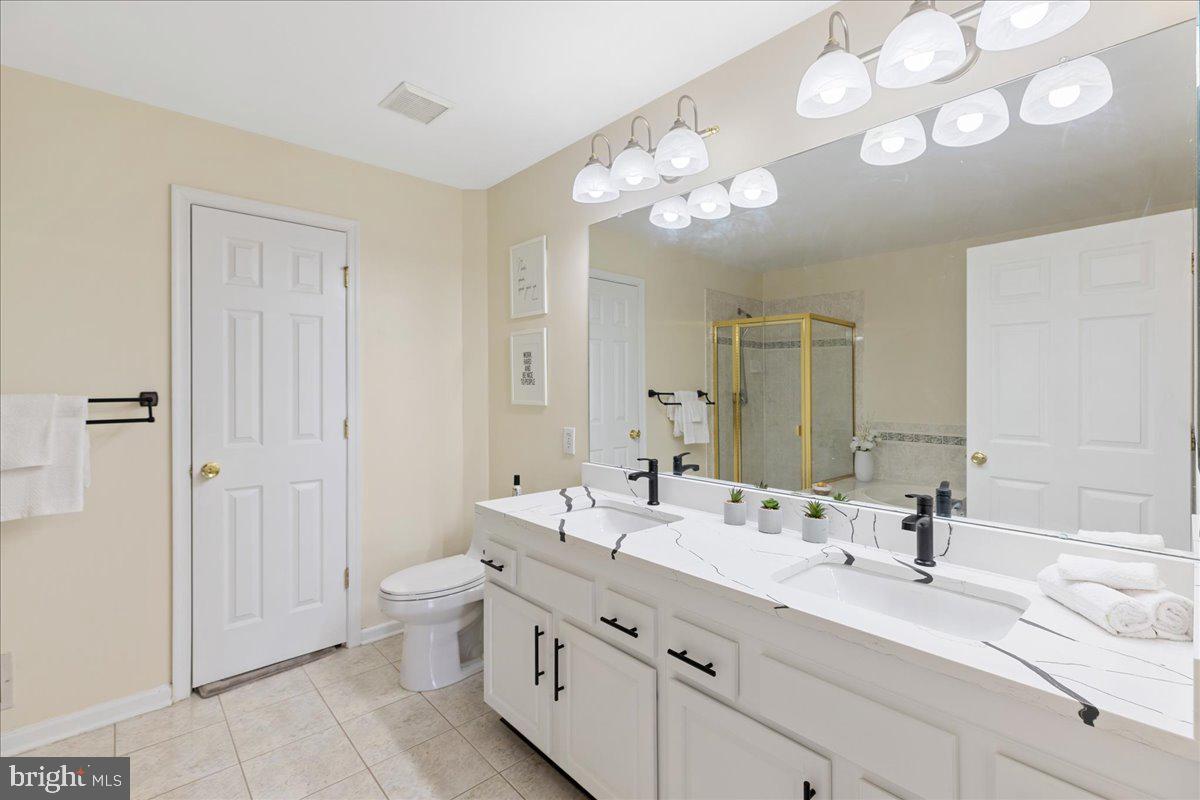 111 Windsor Pond Road Princeton Junction, NJ 08550 - Photo 17 of 29 a bathroom with a double vanity sink mirror and toilet