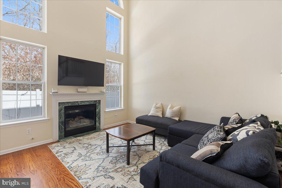 111 Windsor Pond Road Princeton Junction, NJ 08550 - Photo 7 of 29 a living room with furniture a flat screen tv and a fireplace
