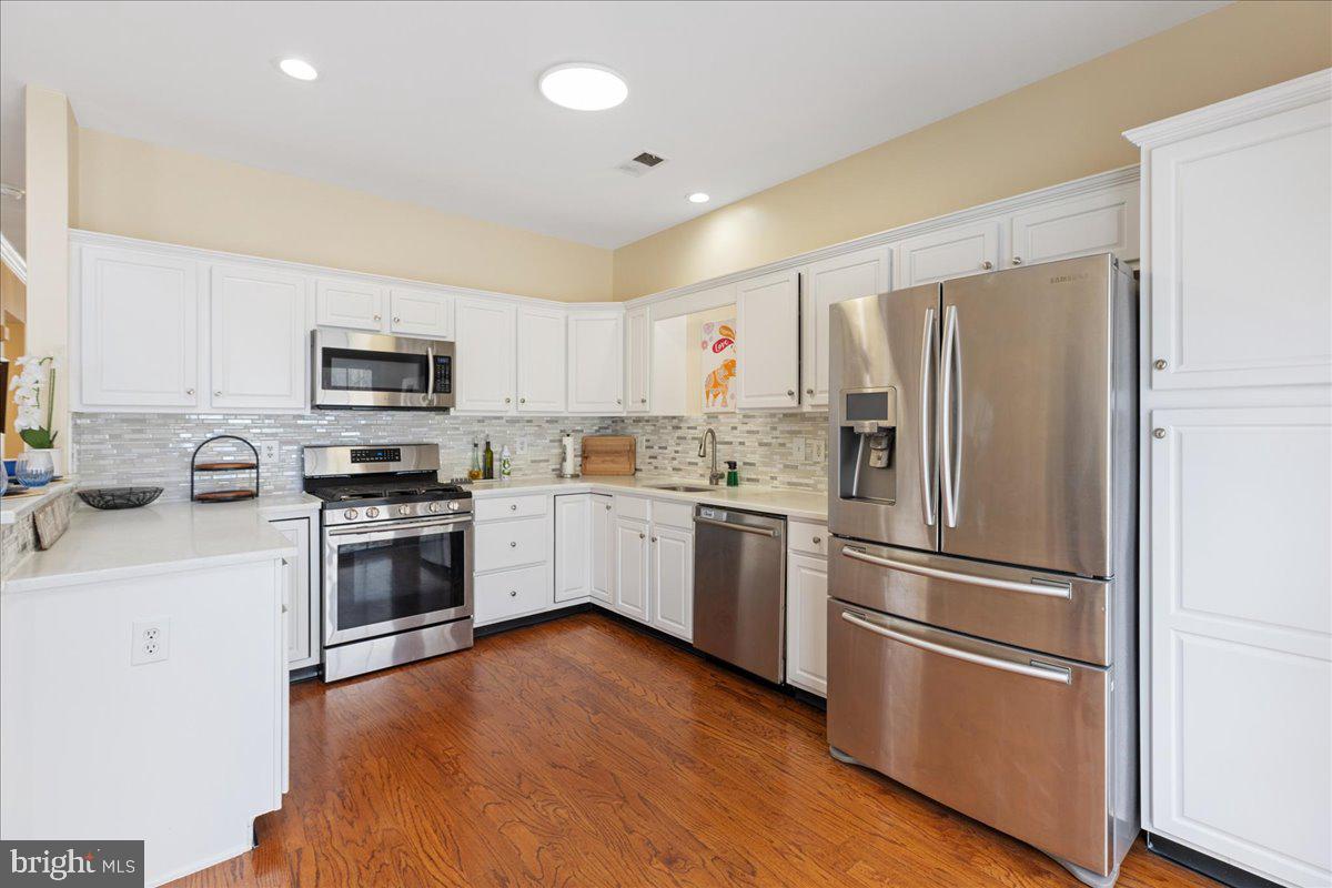 111 Windsor Pond Road Princeton Junction, NJ 08550 - Photo 9 of 29 a kitchen with cabinets stainless steel appliances and a window