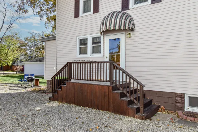 a view of a house with backyard and sitting area