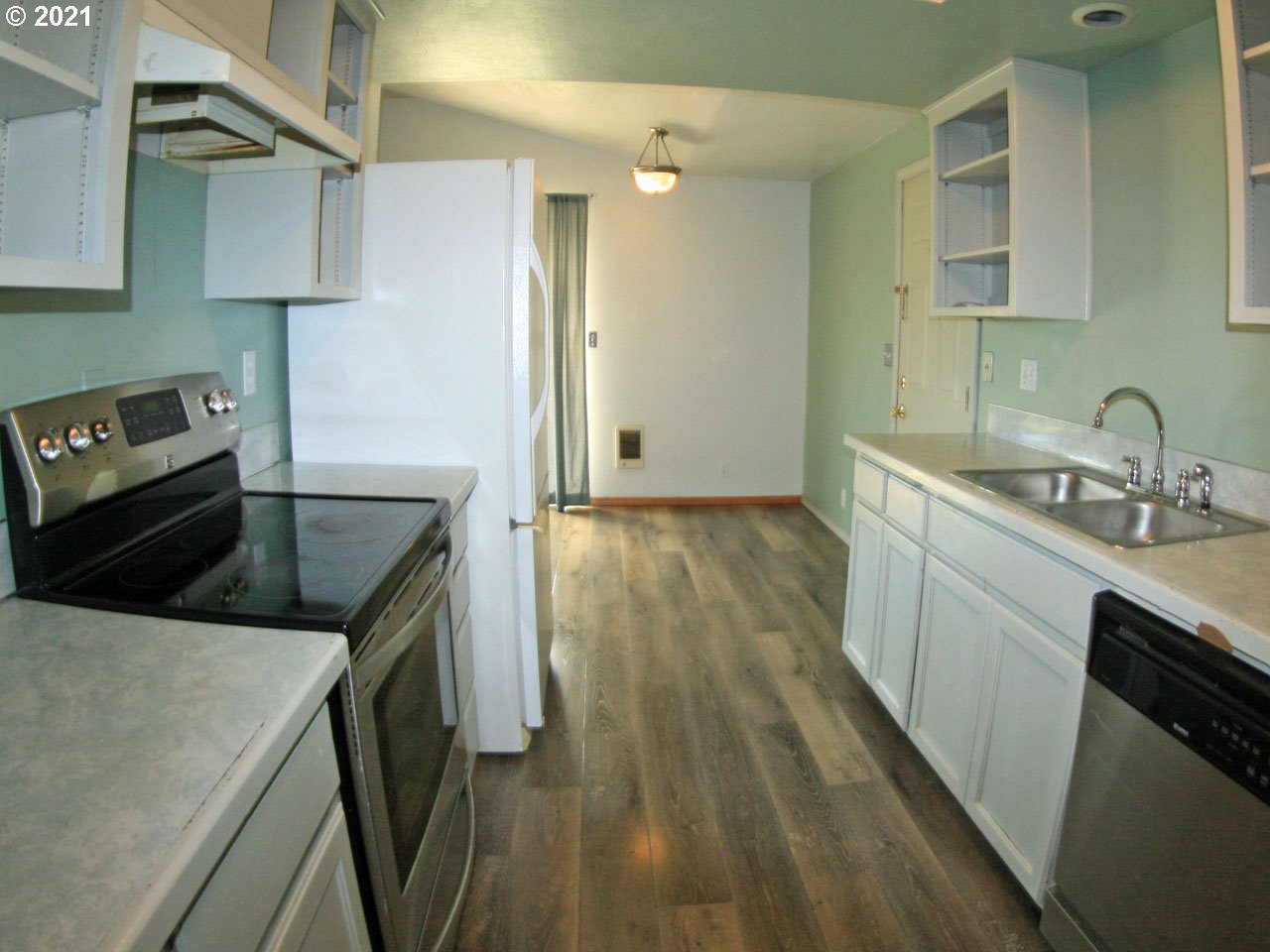 422 North 55th Street Springfield, OR 97478 - Photo 6 of 16 a kitchen that has a sink a stove and cabinets