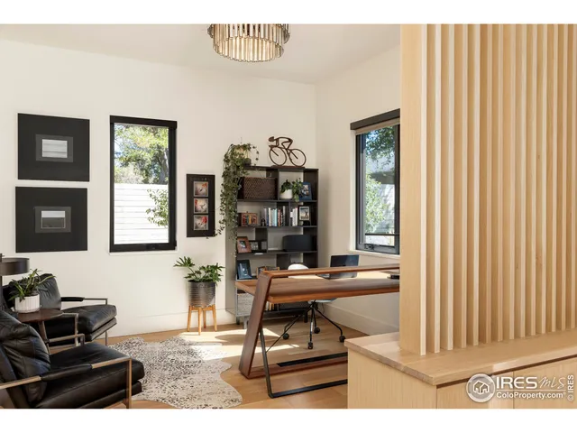 a living room with furniture a piano and a window