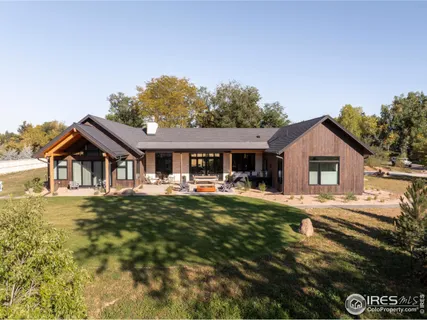 a front view of a house with yard and green space