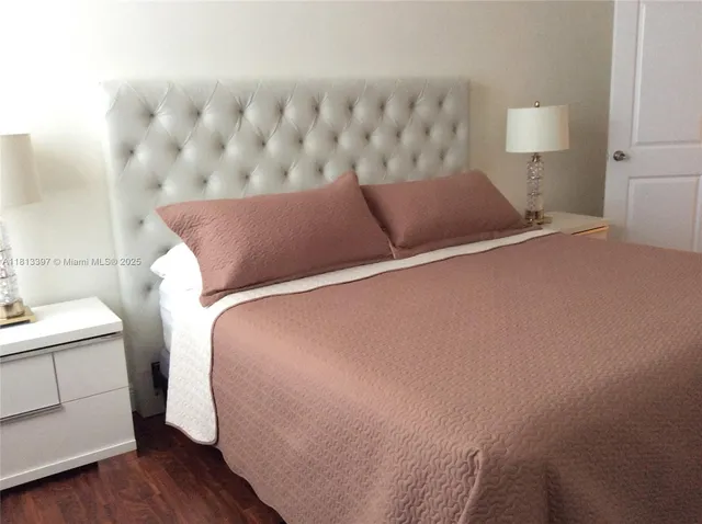 a bedroom with a bed and a lamp