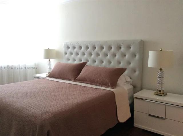 a bedroom with a bed and a table