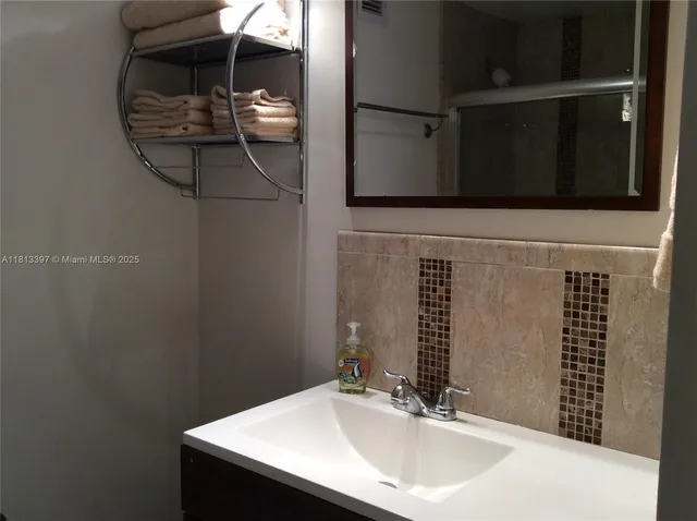 a bathroom with a sink and a mirror