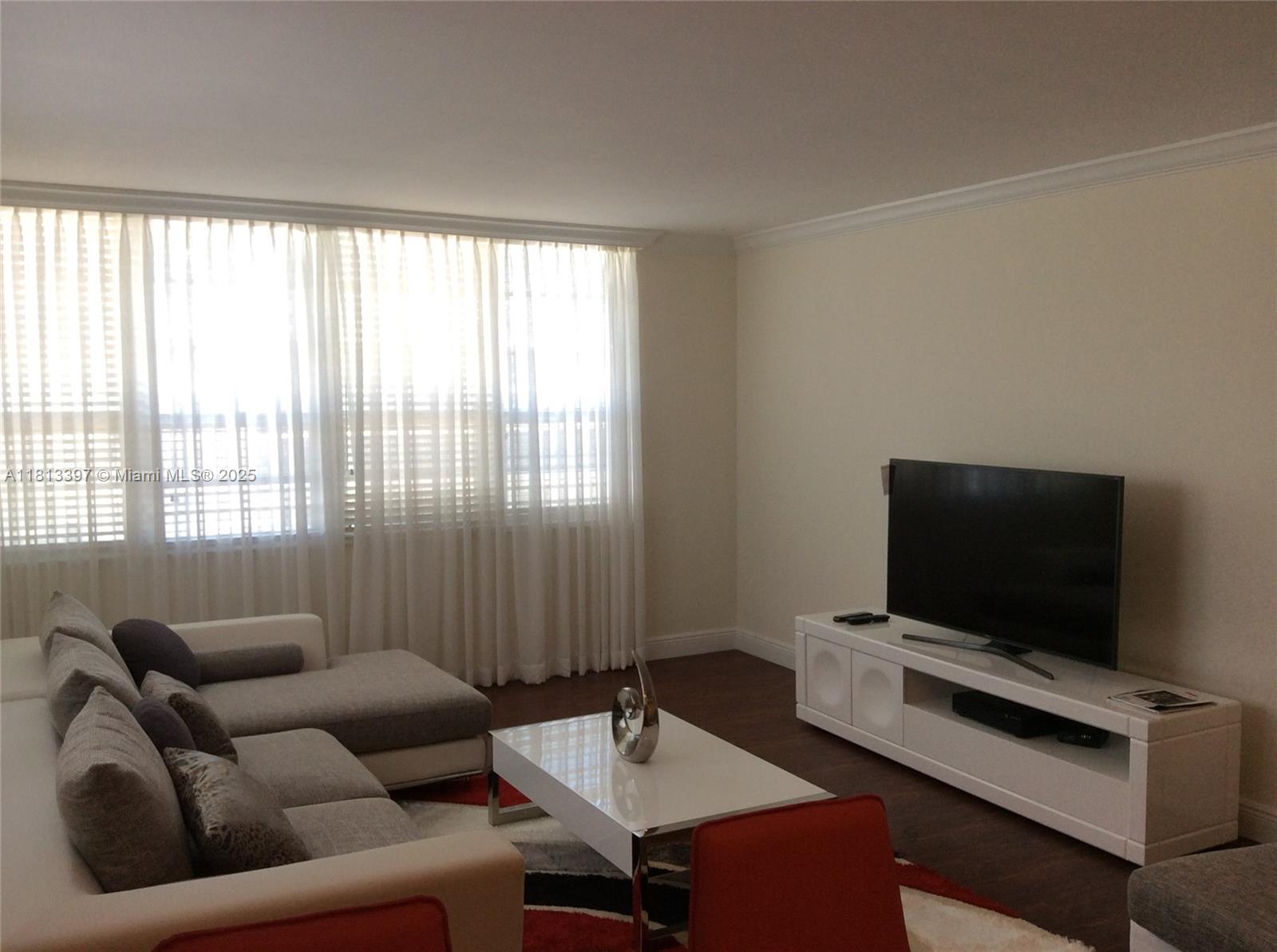100 Lincoln Road, Unit 1214 Miami Beach, FL 33139 - Photo 6 of 17 a living room with furniture and a flat screen tv