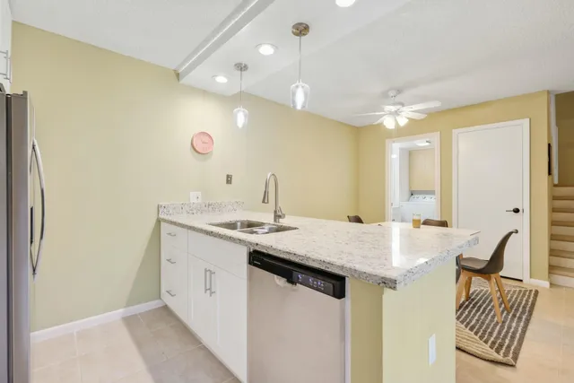 a kitchen with a sink and a refrigerator