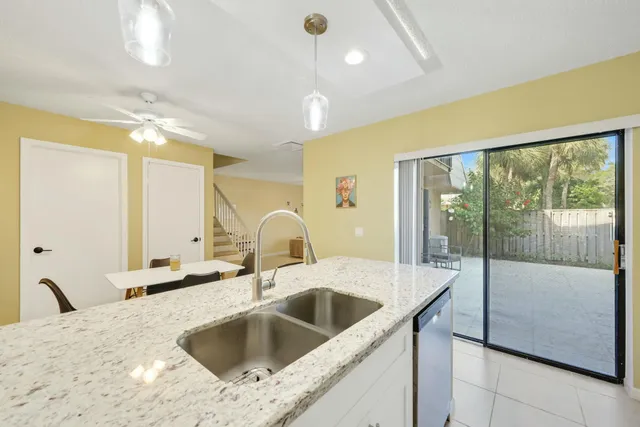 a kitchen with a sink and a refrigerator