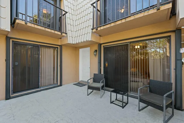 a backyard of a house with table and chairs