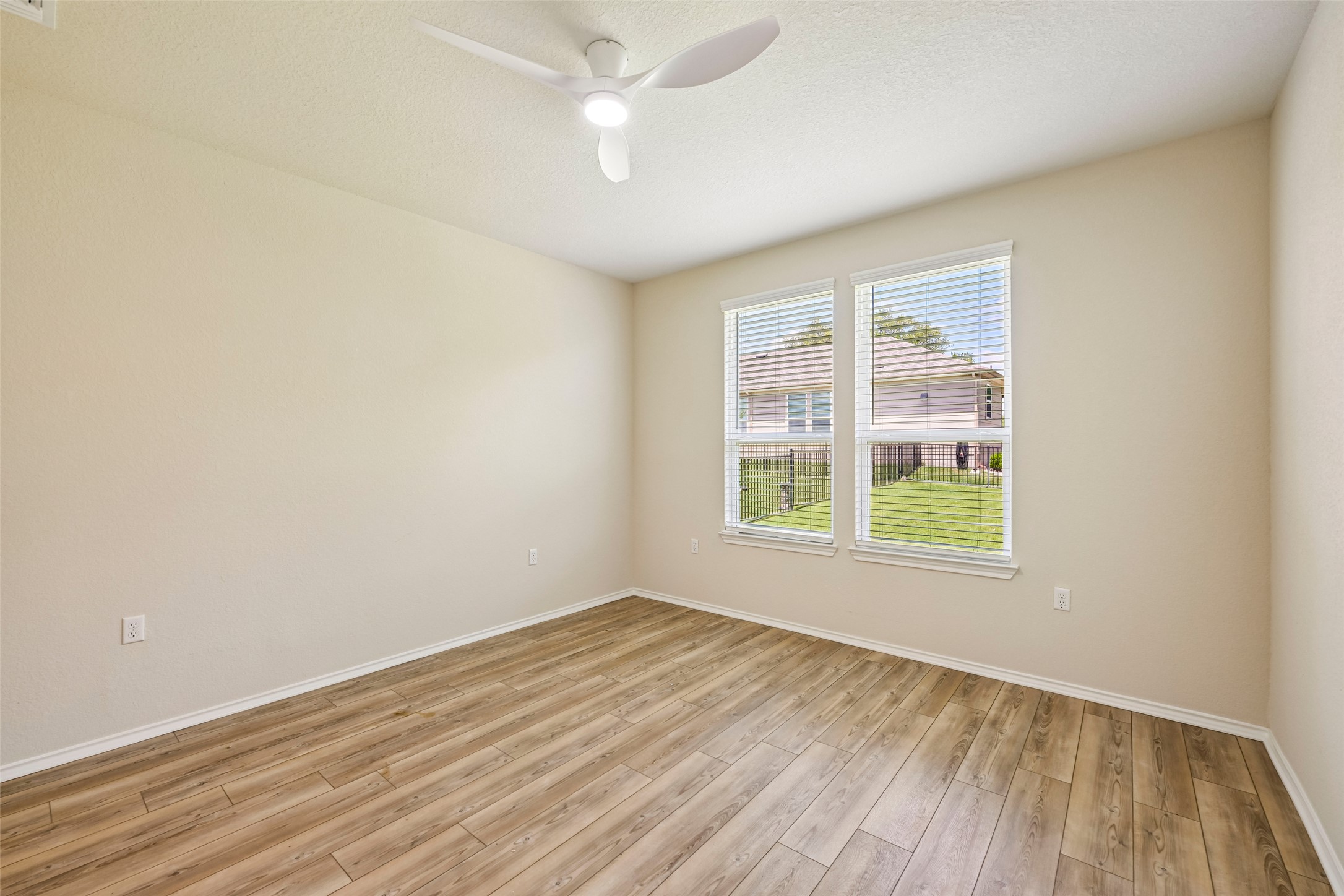 401 Yorktown Street Georgetown, TX 78633 - Photo 19 of 38 Spacious room featuring wood-finish flooring, neutral-toned walls, and a contemporary ceiling fan