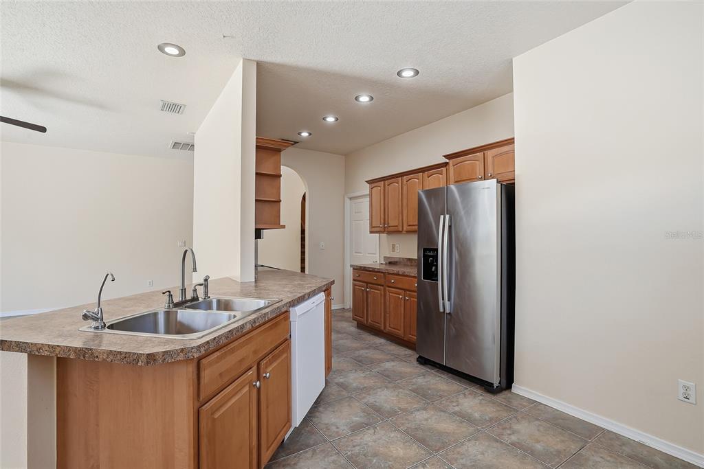 1934 Old Sawmill Road Brandon, FL 33510 - Photo 12 of 40 a kitchen with stainless steel appliances granite countertop a sink stove and refrigerator