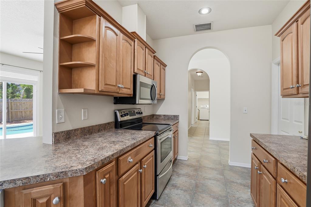 1934 Old Sawmill Road Brandon, FL 33510 - Photo 13 of 40 a kitchen with granite countertop a stove a sink and a microwave