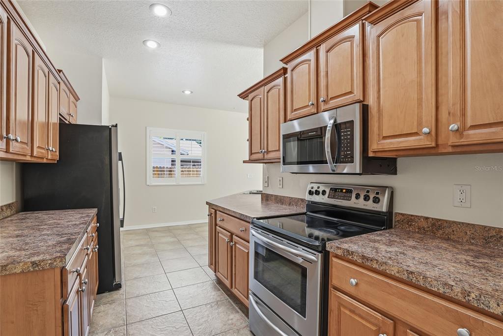 1934 Old Sawmill Road Brandon, FL 33510 - Photo 14 of 40 a kitchen with stainless steel appliances granite countertop a stove and a microwave
