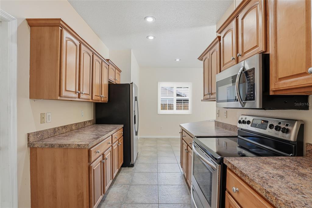 1934 Old Sawmill Road Brandon, FL 33510 - Photo 15 of 40 a kitchen with stainless steel appliances granite countertop a stove and a sink