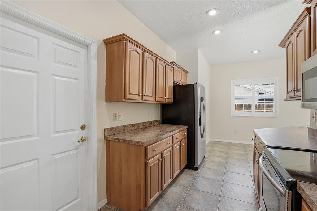 1934 Old Sawmill Road Brandon, FL 33510 - Photo 16 of 40 a kitchen with stainless steel appliances granite countertop a refrigerator and a stove