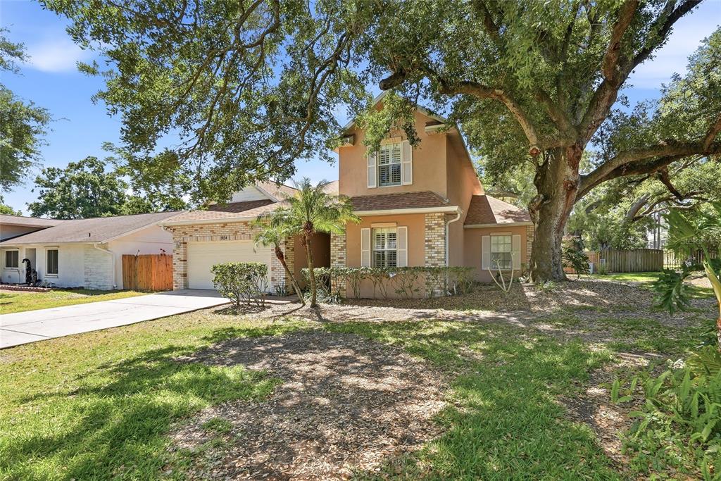 1934 Old Sawmill Road Brandon, FL 33510 - Photo 2 of 40 a white house that has a tree in front of it