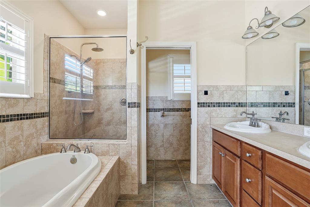 1934 Old Sawmill Road Brandon, FL 33510 - Photo 24 of 40 a bathroom with a tub sink shower and mirror