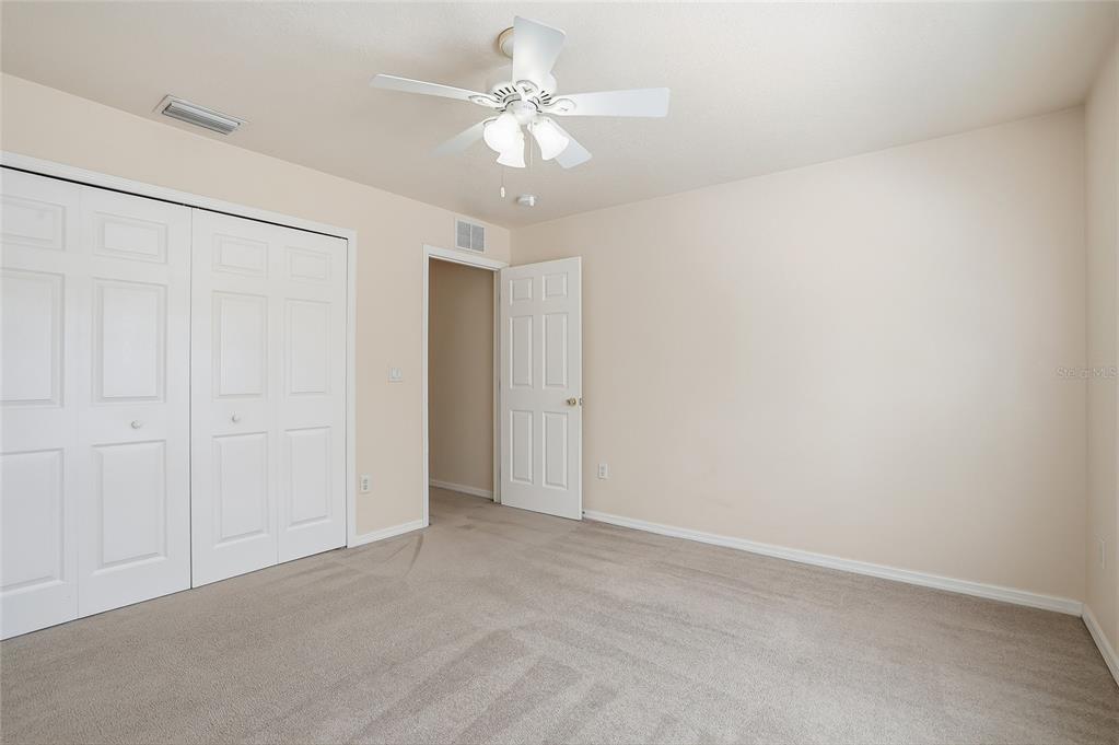 1934 Old Sawmill Road Brandon, FL 33510 - Photo 32 of 40 an empty room with a ceiling fan and a chandelier fan