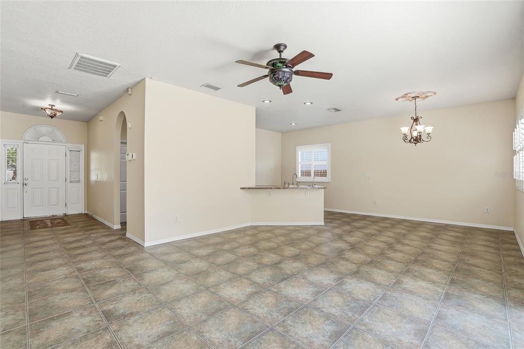1934 Old Sawmill Road Brandon, FL 33510 - Photo 8 of 40 a view of a big room with a chandelier fan and windows