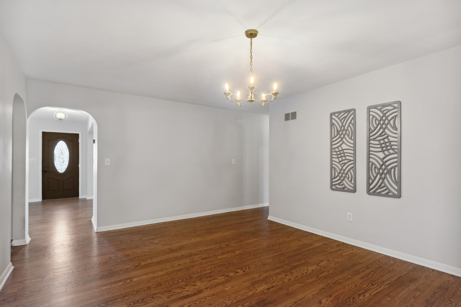 26075 Riverview Drive Antioch, IL 60002 - Photo 11 of 41 a view of a hallway with wooden floor and a chandelier