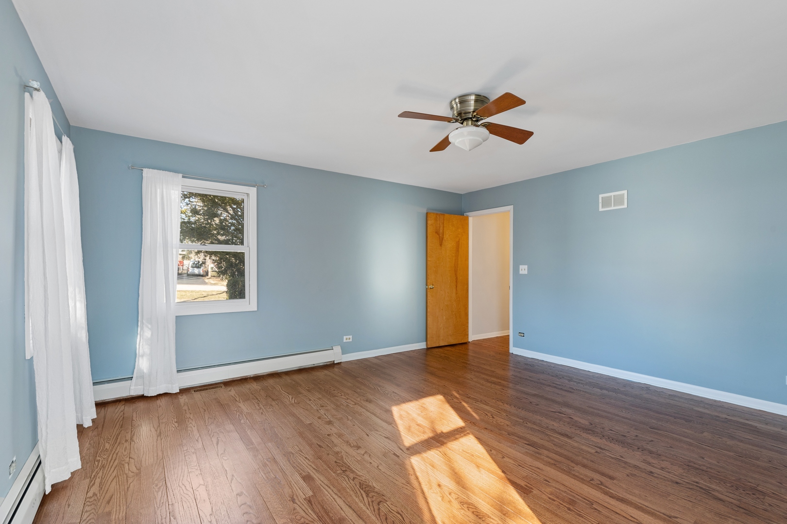 26075 Riverview Drive Antioch, IL 60002 - Photo 20 of 41 a view of an empty room with window and wooden floor